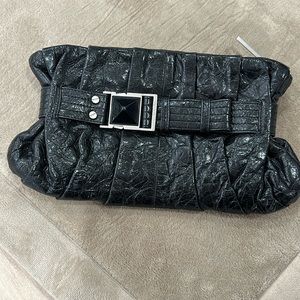 L.A.M.B black clutch with detailed large stone.